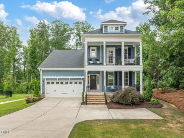 Charming two-story home with a two car garage and inviting double porches at 1804 Amberly Ledge Way, Cary, NC 27519