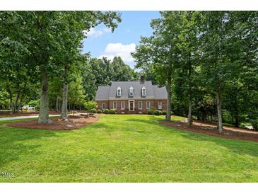 Charming brick home with a large front yard and mature trees at 305 Lochridge Dr, Roxboro, NC 27573