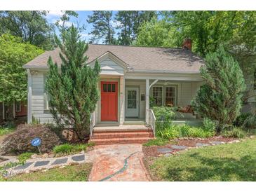 Charming single-story home featuring a front porch and a well-manicured yard at 414 W Markham Ave, Durham, NC 27701