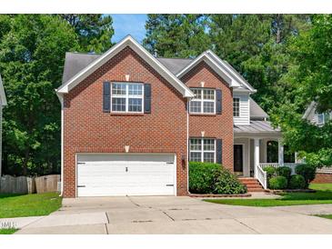 Inviting two-story brick home with a two-car garage and well-maintained landscaping at 4804 Carmen Ln, Durham, NC 27707