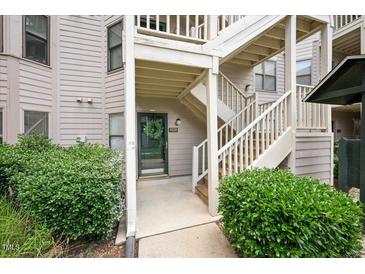 Charming condo entrance with a wreath on the door and well-maintained landscaping at 600 Audubon Lake Dr # 4B11, Durham, NC 27713
