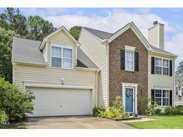Two-story home featuring a combination of brick and siding, with an attached garage and well-maintained front yard at 601 Texanna Way, Holly Springs, NC 27540