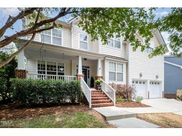 Charming two-story home featuring a welcoming front porch with a swing and a well-manicured lawn at 10847 Bedfordtown Dr, Raleigh, NC 27614
