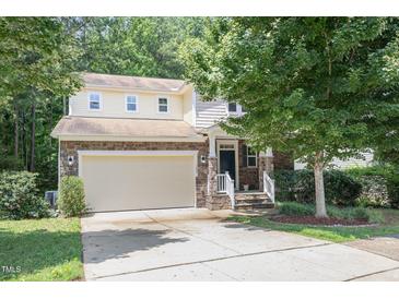 Charming two-story home with a stone facade, attached garage, and well-manicured front yard at 1304 Barnford Mill Rd, Wake Forest, NC 27587