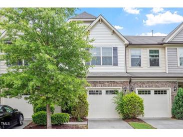 Charming townhome with stone accents, two-car garage, and well-manicured landscaping in a desirable neighborhood at 140 Token House Rd, Durham, NC 27703