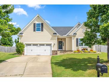 Charming single-Gathering home with a well-maintained lawn, attached garage, and inviting curb appeal at 1400 Manley Ct, Fuquay Varina, NC 27526