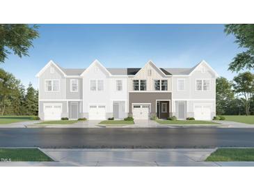 New construction townhome with stylish gray and brown color scheme on a tree lined street at 172 Paramount Dr, Smithfield, NC 27577