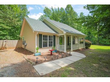Charming single-story home featuring a cozy front porch and well-maintained landscaping at 2116 Sterling Creek Ln, Franklinton, NC 27525