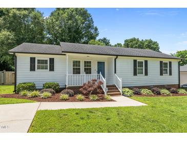 Charming single-story home features white siding, dark shutters, and a well-manicured front yard at 2324 Hoskins Rd, Burlington, NC 27215