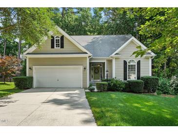 Charming single-story home with well-manicured lawn, attached garage, and welcoming front entrance at 2425 Lemuel Dr, Raleigh, NC 27615