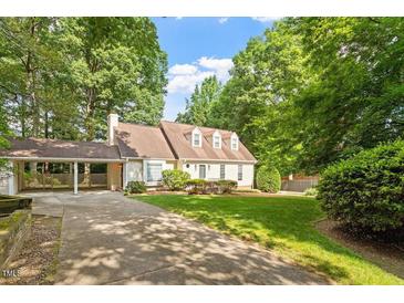 Charming home with a well-manicured lawn and beautiful trees at 3705 Old Post Rd, Raleigh, NC 27612
