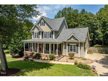 Charming two-story home featuring a welcoming front porch and beautifully landscaped front yard at 5712 Turner Store Ln, Raleigh, NC 27603