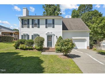 Charming two-story home featuring a well-manicured lawn, white siding, black shutters, and an attached garage at 105 Leacroft Way, Durham, NC 27703