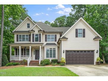 Traditional two-story home with a porch, dormers, and attached garage at 117 Garden Oaks Dr, Smithfield, NC 27577