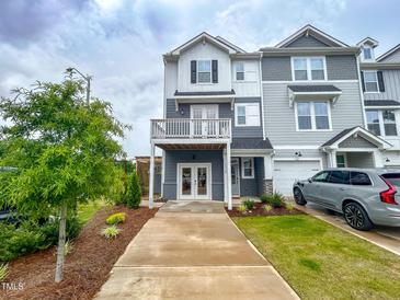 Attractive gray townhome with a two-story elevation and a well-manicured front yard at 124 Sugar Run Dr # 11, Fuquay Varina, NC 27526