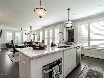 Bright kitchen features a spacious island, modern appliances, and stylish lighting at 1610 Draper View Loop # 101, Raleigh, NC 27608