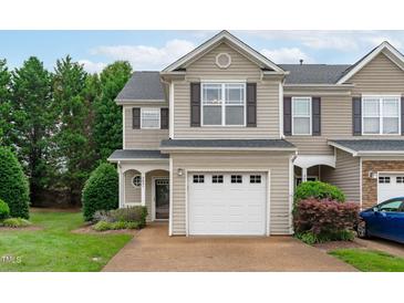 Charming townhome with neutral siding, attached garage, and well-maintained landscaping at 2621 Asher View Ct, Raleigh, NC 27606