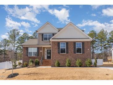 Charming two-story home with brick and siding exterior, manicured lawn, and inviting entrance at 40 Ironwood Blvd, Youngsville, NC 27596