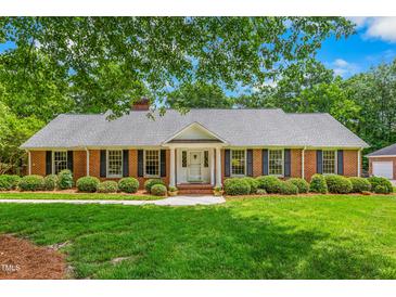 Charming brick home with manicured lawn and mature landscaping at 417 N Gurney St, Burlington, NC 27215