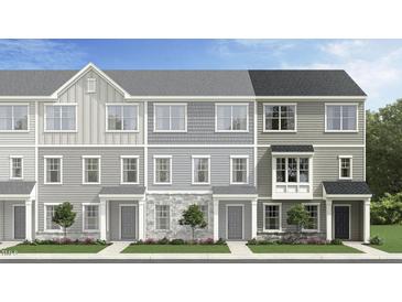 Charming townhomes showcasing a variety of light gray exterior colors, materials, and stylish architectural details at 474 Carolina Springs Dr, Apex, NC 27539