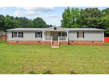 Charming single-story home with a covered porch and a well-maintained lawn at 558 Christys Way, Roxboro, NC 27574