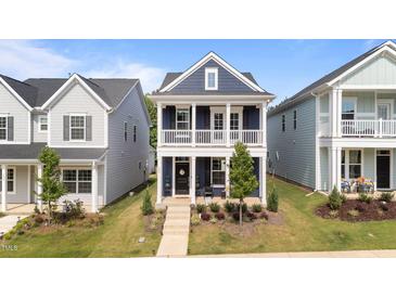 Charming two-story home featuring a welcoming front porch, well-manicured lawn, and traditional architectural details at 627 Georgias Landing Pkwy, Raleigh, NC 27603