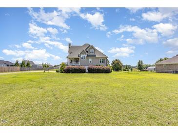 Charming two-story home with beautiful landscaping, a spacious yard, and classic architectural details at 656 Atkins Rd, Fuquay Varina, NC 27526