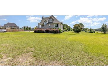 Charming home with lush front lawn and manicured shrubbery, offering a peaceful and inviting curb appeal at 656 Atkins Rd, Fuquay Varina, NC 27526