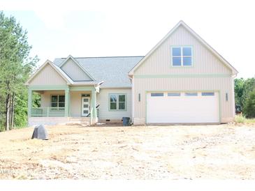 Charming new construction with a two-car garage and front porch, perfect for enjoying the outdoors at 70 Basil Ct, Franklinton, NC 27525