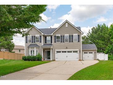 Charming two-story home with attached two car garage and detached garage with manicured lawn at 760 Stackhurst Way, Wake Forest, NC 27587