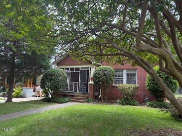 Charming single-story brick home with mature landscaping at 921 Alabama Ave, Durham, NC 27705