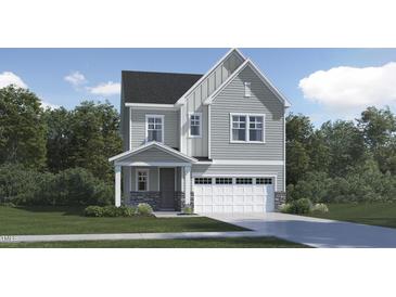 Charming two-story home showcasing a gray exterior, a front porch, an attached two-car garage, and a well-maintained lawn at 1240 Coral Cay Bnd, Wake Forest, NC 27587