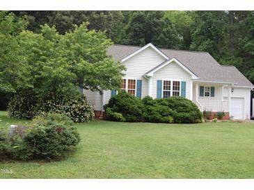 Charming single-story home features a well-maintained lawn and attractive landscaping at 3145 Pier Pointe Dr, Creedmoor, NC 27522