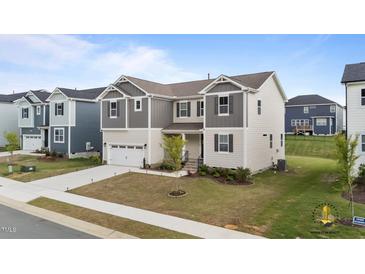 Charming two-story home with neutral siding, gray accents, and a well-manicured lawn at 3421 Lebrun Path, Fuquay Varina, NC 27526