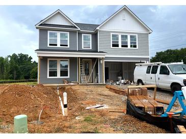 Two-story house with gray siding and white trim during the construction phase showing the front and the bare ground at 35 Windflower Court Ct # Homesite 9, Clayton, NC 27520