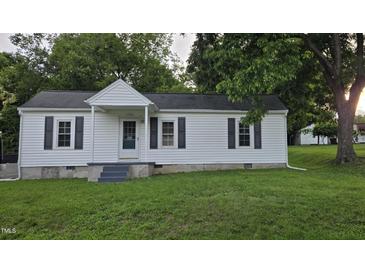 Charming single-story home with white siding, black shutters, and a well-manicured lawn at 426 Smith St, Burlington, NC 27217