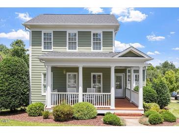 Charming two-story home featuring a welcoming front porch with classic white columns and manicured landscaping at 500 Weaver Mine Trl, Chapel Hill, NC 27517