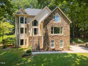 Charming home with stone facade, elegant windows, and inviting front steps at 6001 Waters Way Dr, Raleigh, NC 27606