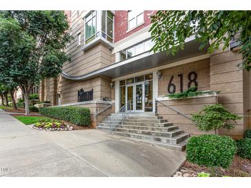 Exterior view of building entrance featuring a modern design and well-manicured landscaping at 618 N Boylan Ave # 520, Raleigh, NC 27603