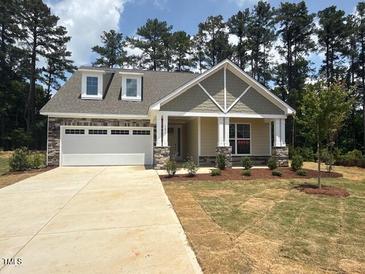 Charming single Gathering home featuring a two-car garage and manicured front lawn at 105 Slippery Elm Rd, Youngsville, NC 27596