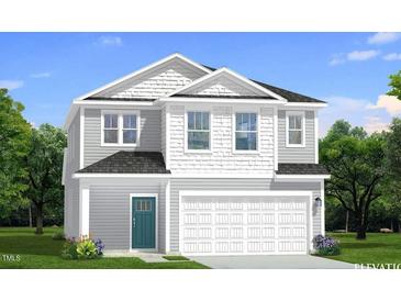 Charming two-story home with a combination of shake and lap siding, complemented by a two-car garage at 1101 Shovelhead Dr # 51, Durham, NC 27703