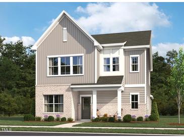 Charming two-story home with a brick and gray siding exterior and a welcoming front porch at 2886 Quarry Rd # 161, Rolesville, NC 27571