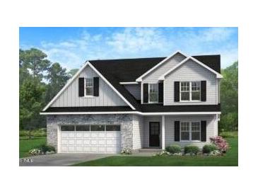 Charming two-story home with stone accents, a two-car garage, and a beautifully landscaped front yard at 368 Abingdon Farms Dr, Selma, NC 27576