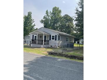 Charming single-story home with a covered front porch and fenced yard at 40 Bait Rd, Dunn, NC 28334