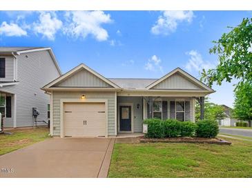 Charming single-Gathering home with a well-manicured lawn and attached one car garage at 51 Balboa Pkwy, Clayton, NC 27520