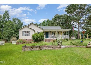 Charming single Gathering home featuring well maintained yard, landscaping and inviting front porch at 559 Blue Pond Rd, Clayton, NC 27520