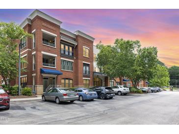 Beautiful brick apartment building with balconies and well-maintained parking lot at 7250 Nc 751 Highway, #1205, Durham, NC 27707