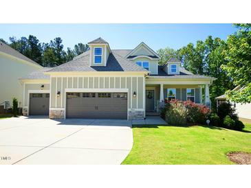 Charming home boasts a well-manicured lawn, attached garage, and welcoming entrance at 966 Airedale Trl, Garner, NC 27529