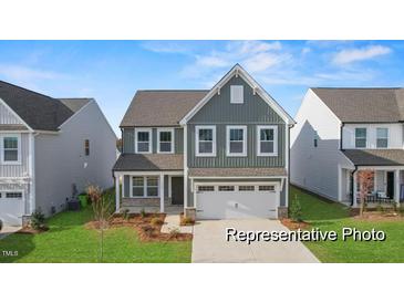 Charming two-story home with gray siding, a well-kept lawn, and a two-car garage at 106 S Buggy Dr # 70, Benson, NC 27504