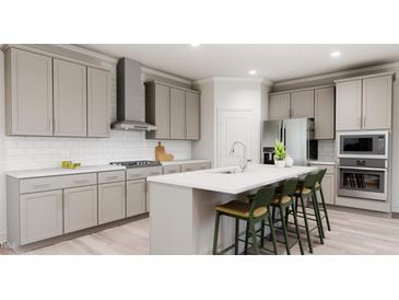 Modern kitchen features a large island with seating, stainless steel appliances and shaker cabinets at 1156 Topaz Cave Cir # 862, Raleigh, NC 27529